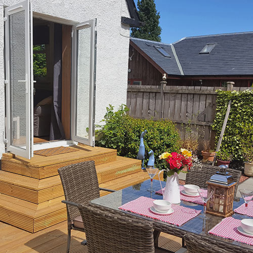 Garden room outside decking and dinning table