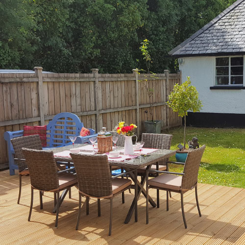 Garden room outside dinning table and grass lawn